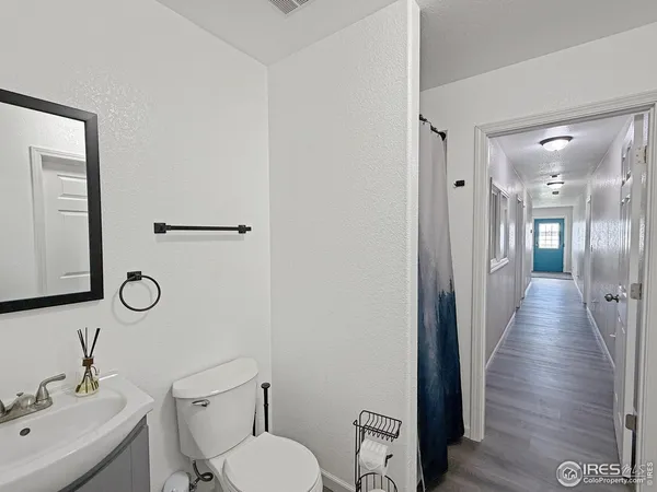 a bathroom with a toilet a sink and mirror