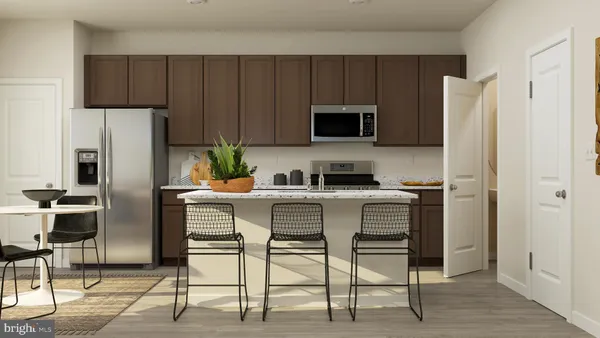 a kitchen with stainless steel appliances a refrigerator stove microwave and cabinets