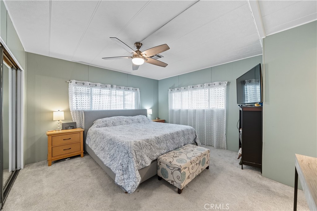 9800 Base Line Road, Unit 79 Rancho Cucamonga, CA 91701 - Photo 14 of 31 a spacious bedroom with a bed a window and dresser