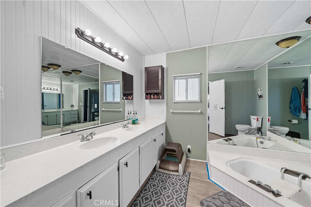 9800 Base Line Road, Unit 79 Rancho Cucamonga, CA 91701 - Photo 17 of 31 a large bathroom with a double vanity sink mirror and bathtub