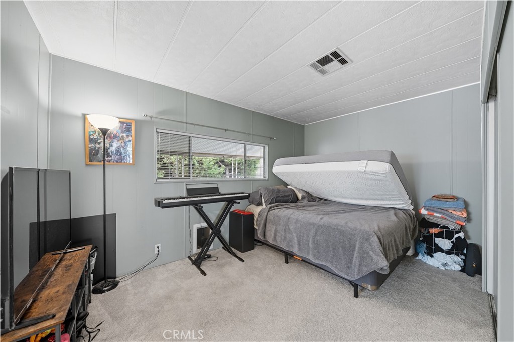 9800 Base Line Road, Unit 79 Rancho Cucamonga, CA 91701 - Photo 19 of 31 a bedroom with a bed and a window