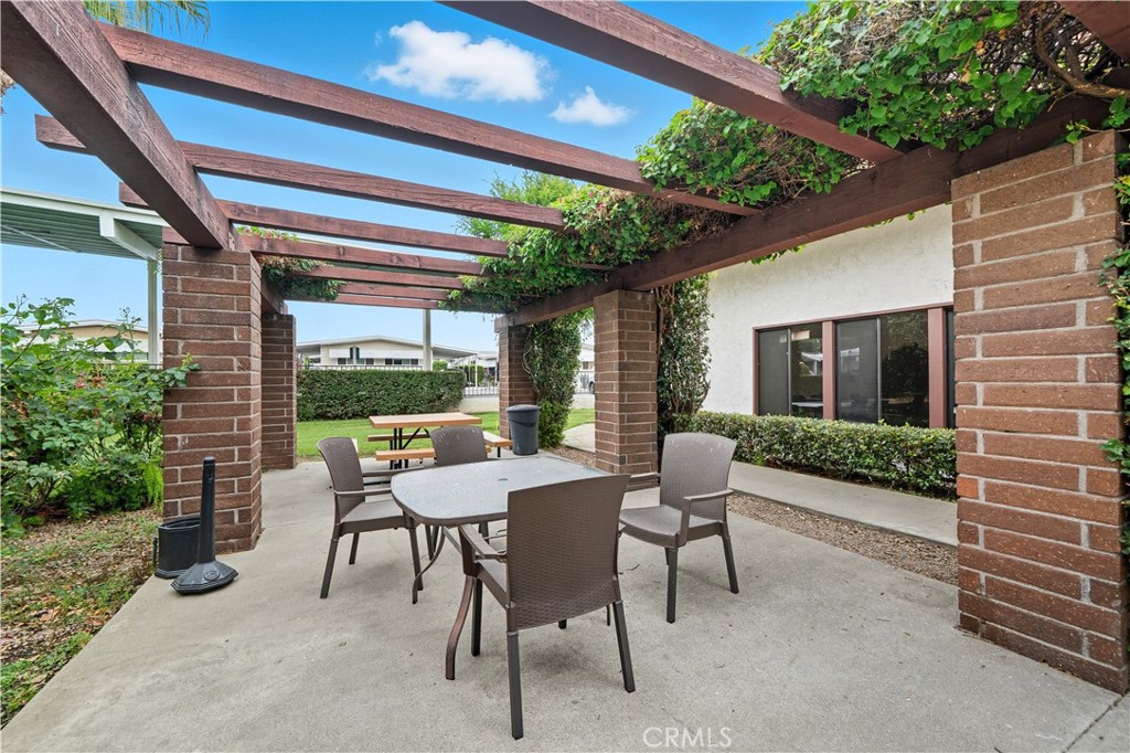 9800 Base Line Road, Unit 79 Rancho Cucamonga, CA 91701 - Photo 28 of 31 a view of a patio with a table and chairs and potted plants