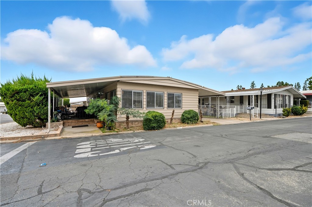 9800 Base Line Road, Unit 79 Rancho Cucamonga, CA 91701 - Photo 3 of 31 a view of a building with a yard