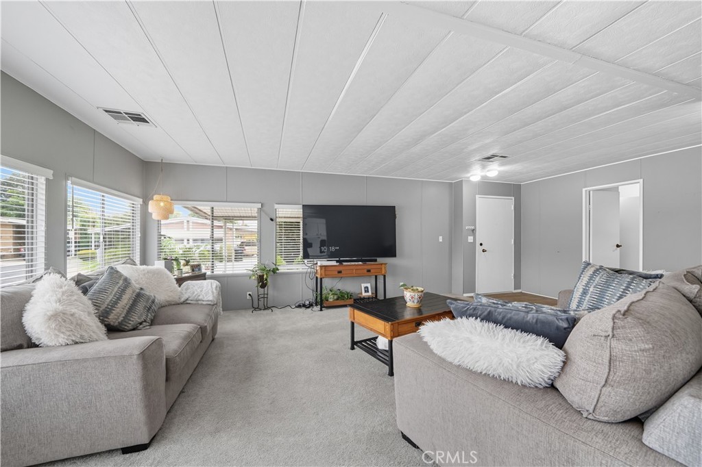 9800 Base Line Road, Unit 79 Rancho Cucamonga, CA 91701 - Photo 6 of 31 a living room with furniture and a flat screen tv