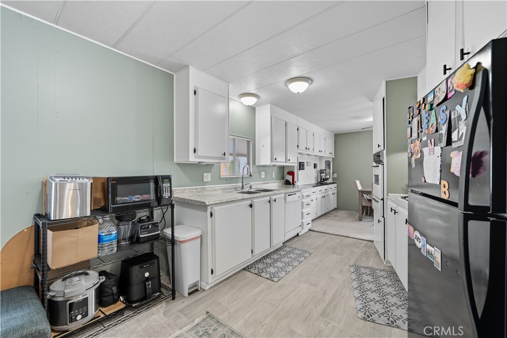9800 Base Line Road, Unit 79 Rancho Cucamonga, CA 91701 - Photo 9 of 31 a kitchen with a sink cabinets and appliances