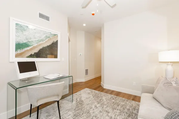 a living room with a bed furniture and a flat screen tv