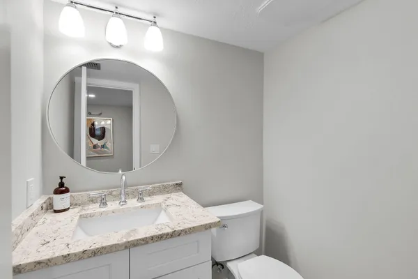 a living room with furniture a large window and dining table