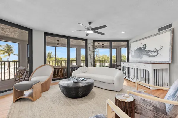 a living room with furniture a large window and a clock