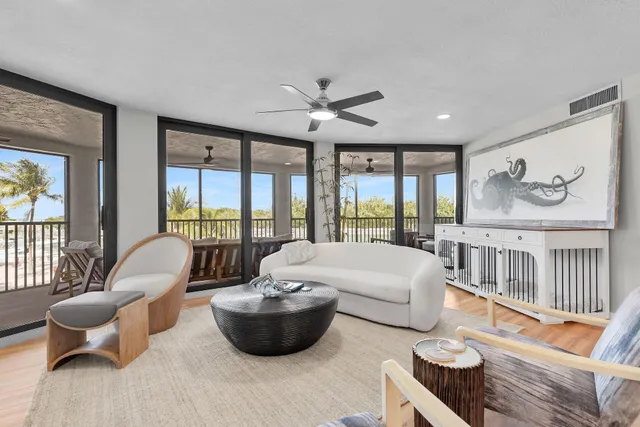 a living room with furniture a large window and a clock