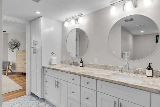 a bedroom with a large bed and a chandelier