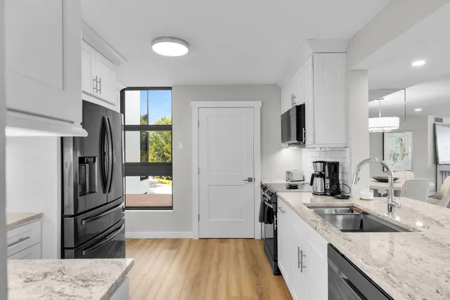 a kitchen with a refrigerator and a sink