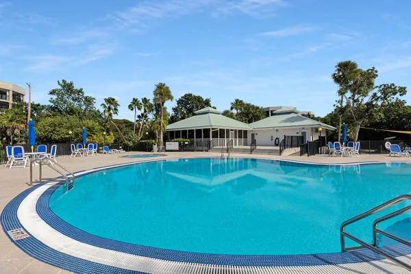 a kitchen with stainless steel appliances granite countertop a dining table chairs and a fireplace