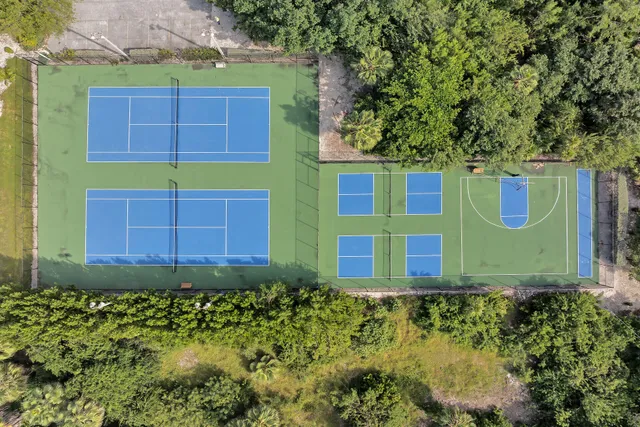 a living room with furniture and floor to ceiling windows