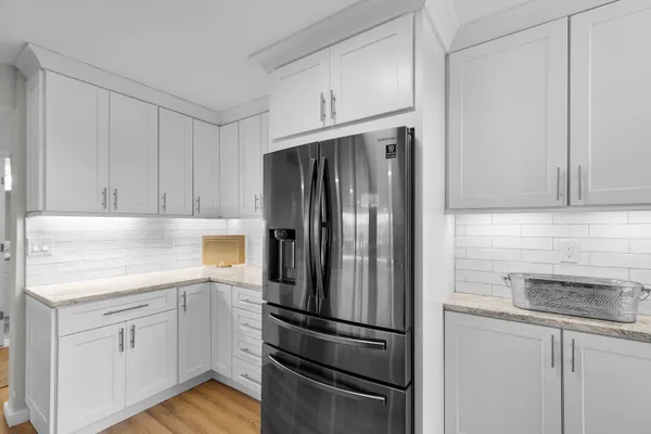 a kitchen with stainless steel appliances granite countertop a sink and refrigerator