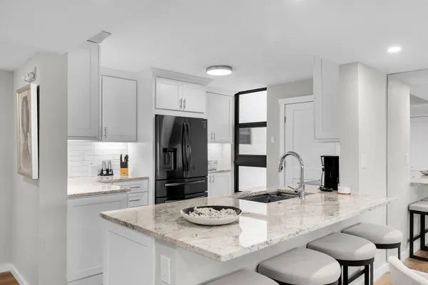 a kitchen with stainless steel appliances kitchen island a sink and cabinets