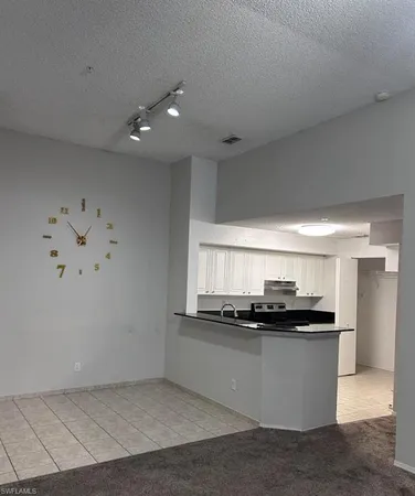 a kitchen with kitchen island stainless steel appliances a sink a stove and a refrigerator