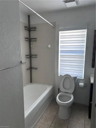 a bathroom with a toilet and a bathtub