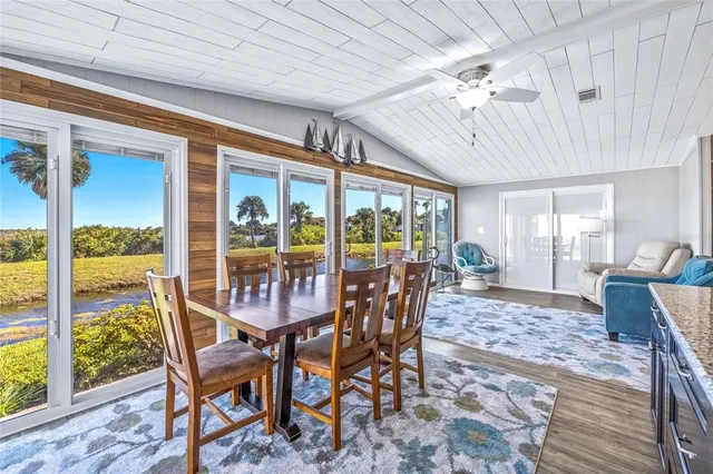 a spacious bedroom with a bed and glass windows