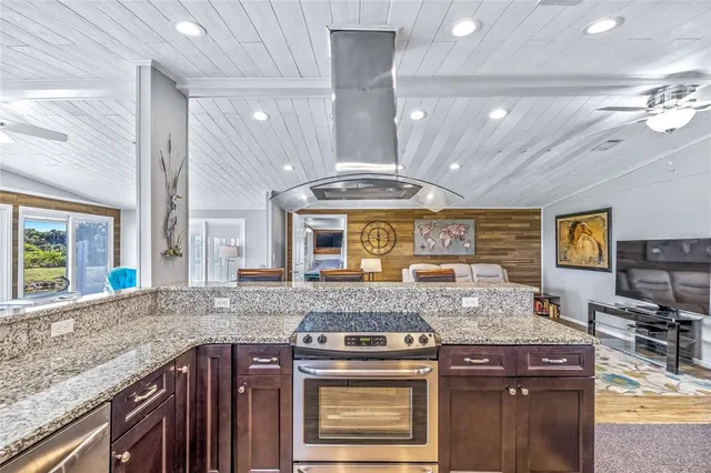 a kitchen with granite countertop a sink and a window