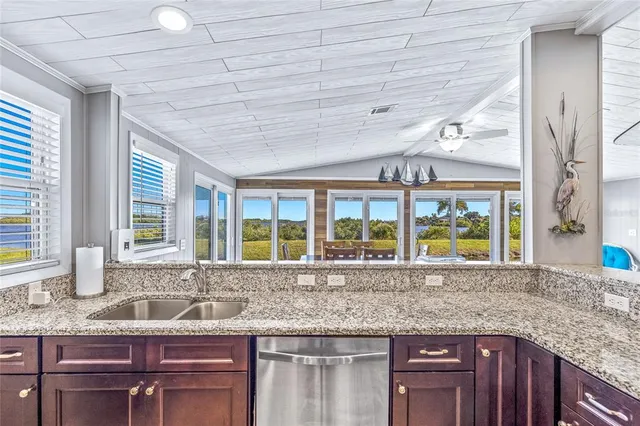 a view of a house with swimming pool and sitting area