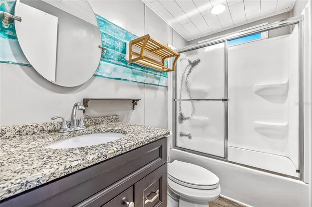 a spacious bedroom with a bed and a chandelier