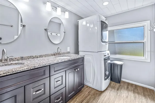 a view of an empty room with floor to ceiling windows and wooden floor