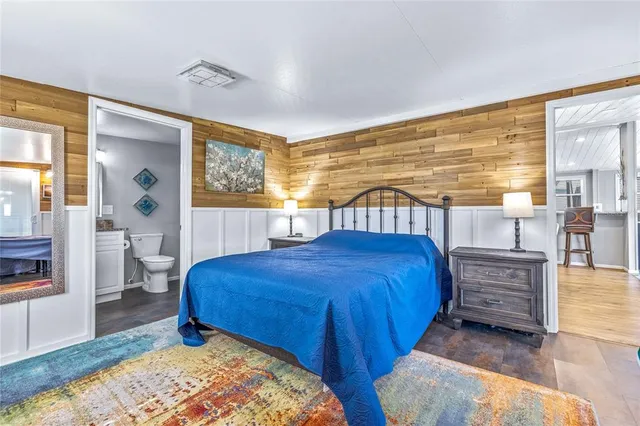 an aerial view of a house with a garden and lake view