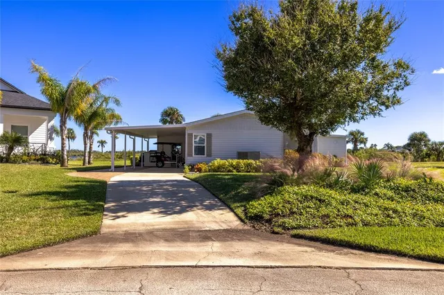 a living room with furniture floor to ceiling window and wooden floor