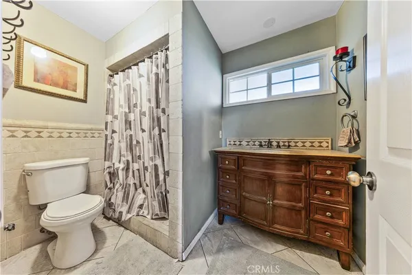 a bedroom with a bed wooden floor and window