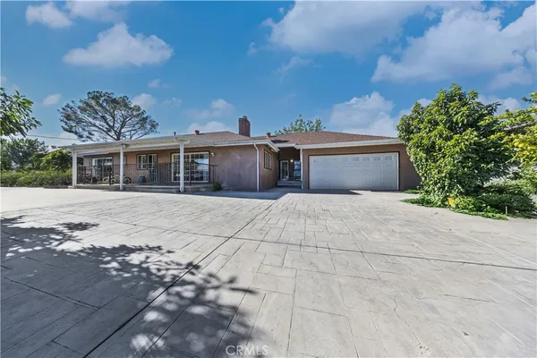 a living room with stainless steel appliances kitchen island granite countertop a couch and a view of living room
