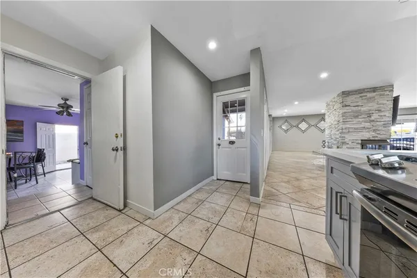 a bedroom with a bed and a potted plant on dresser