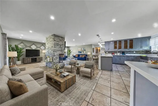 a living room with furniture and kitchen view