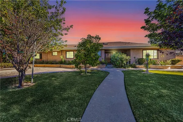 an aerial view of a house with a yard and lake view