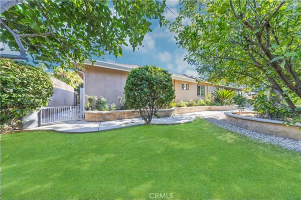 an aerial view of a house with a yard and potted plants