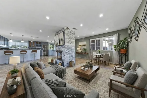 a kitchen with stainless steel appliances granite countertop a refrigerator and a stove top oven