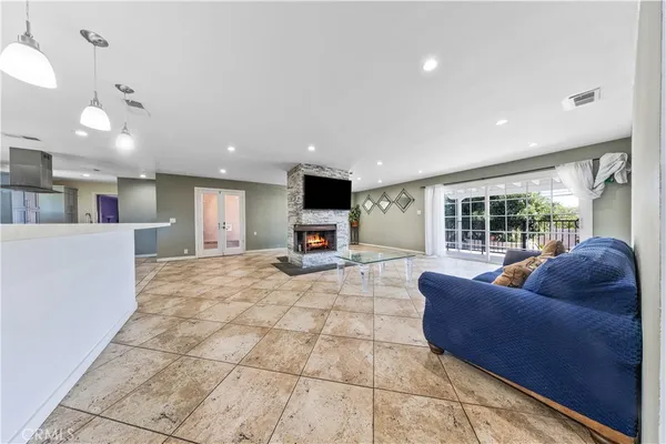 a view of kitchen with kitchen island stainless steel appliances refrigerator sink stove and cabinets