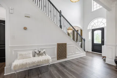 a living room with furniture and a chandelier