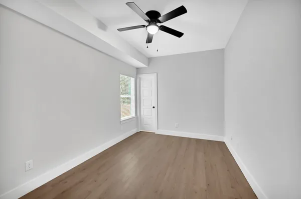 wooden floor in an empty room with a window