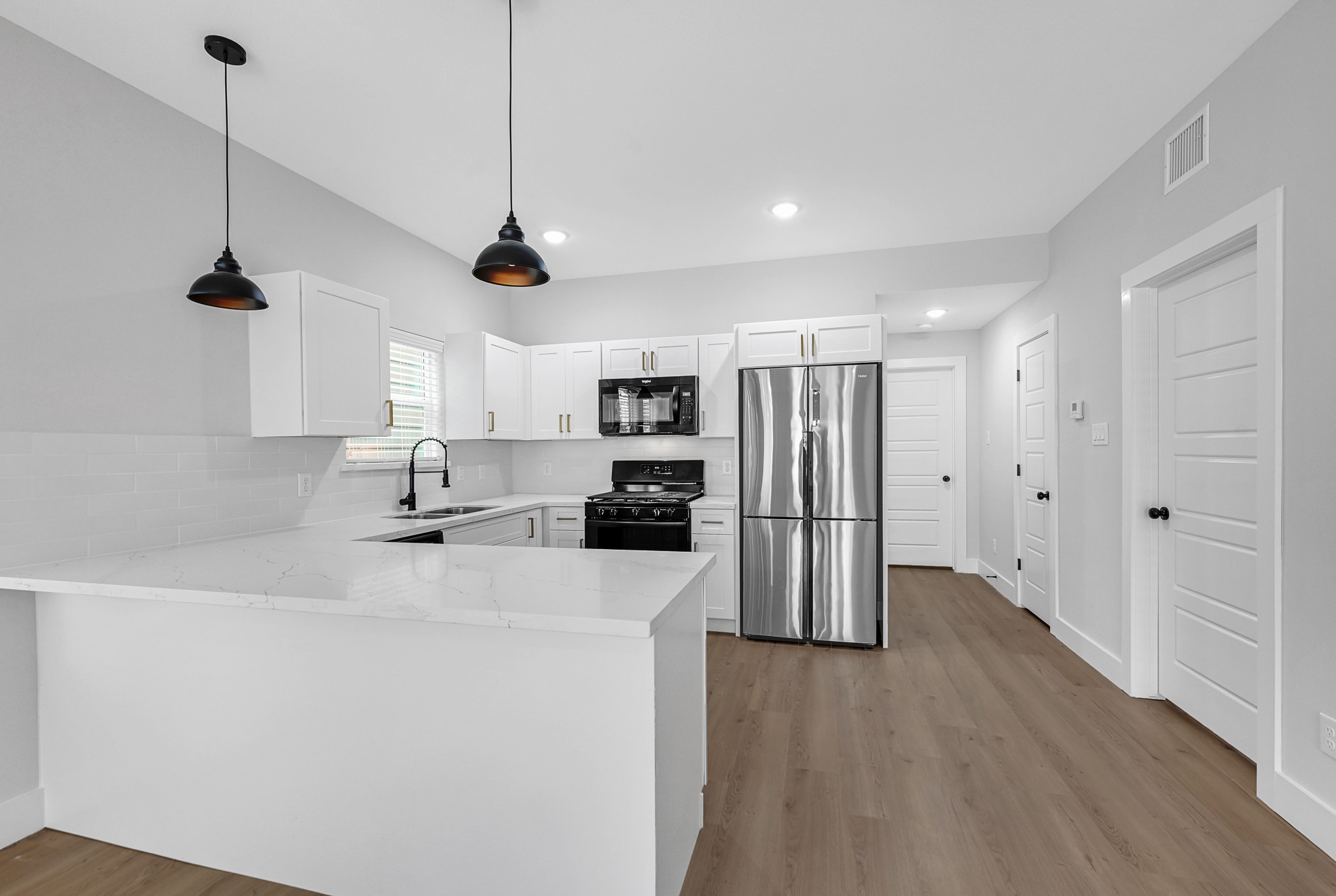 3312 Bacchus Street, Unit A Houston, TX 77022 - Photo 2 of 23 Open concept kitchen. with stainless steel appliances.