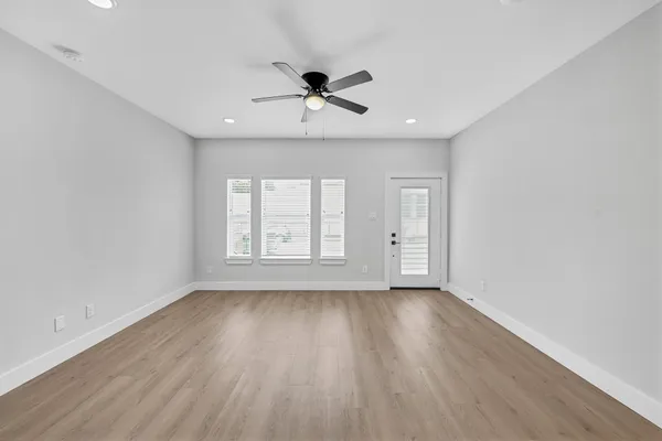 wooden floor in an empty room with a window