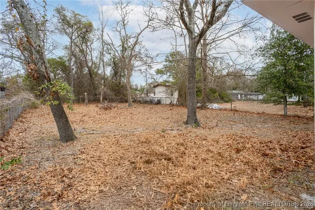 a front view of a house with a yard covered with snow