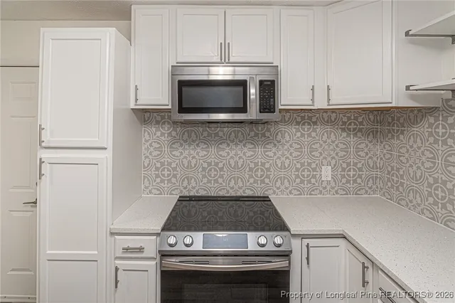 a stove top oven sitting inside of a kitchen