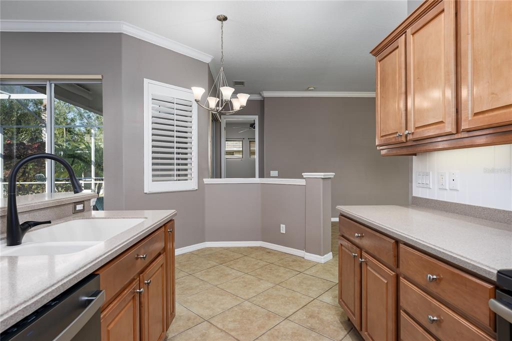 12150 Mapleridge Drive Parrish, FL 34219 - Photo 13 of 38 a kitchen with a sink stove and cabinets