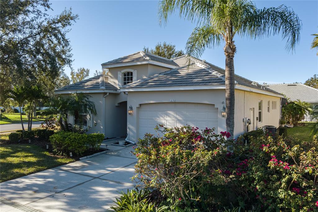 12150 Mapleridge Drive Parrish, FL 34219 - Photo 2 of 38 a front view of a house with garden