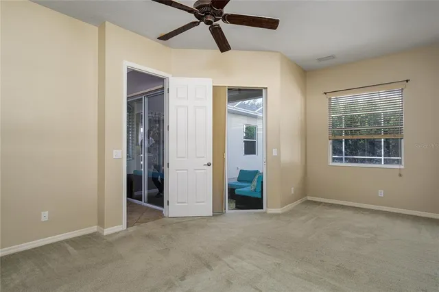 an empty room with windows and closet