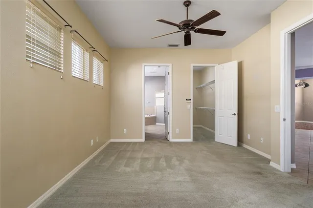 a view of an empty room with a ceiling fan