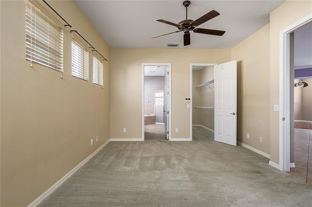 12150 Mapleridge Drive Parrish, FL 34219 - Photo 23 of 38 a view of an empty room with a ceiling fan