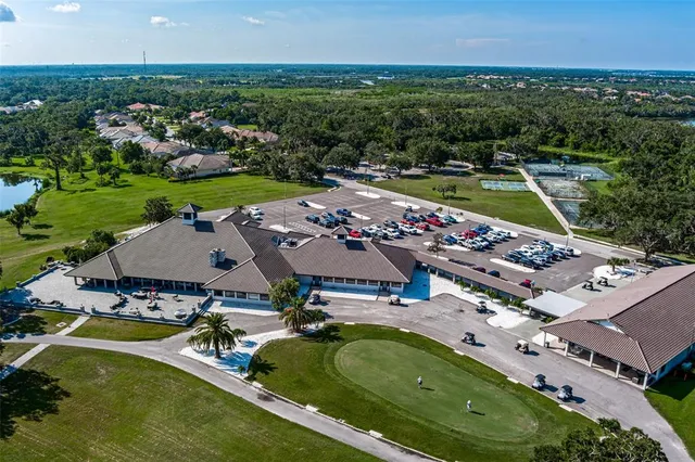 an aerial view of a house with a garden swimming pool and outdoor seating