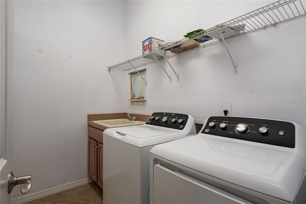 12150 Mapleridge Drive Parrish, FL 34219 - Photo 8 of 38 a utility room with dryer and washer