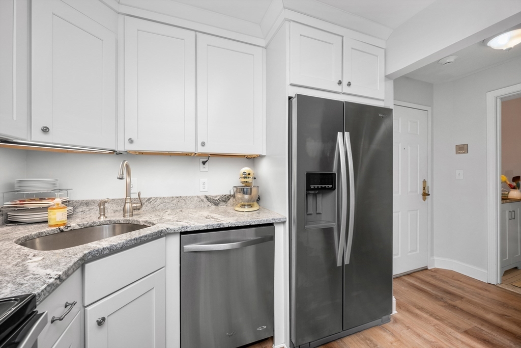 9 Park Hull Ma, Unit 505 Hull, MA 02045 - Photo 15 of 25 a kitchen with stainless steel appliances granite countertop a refrigerator sink and cabinets
